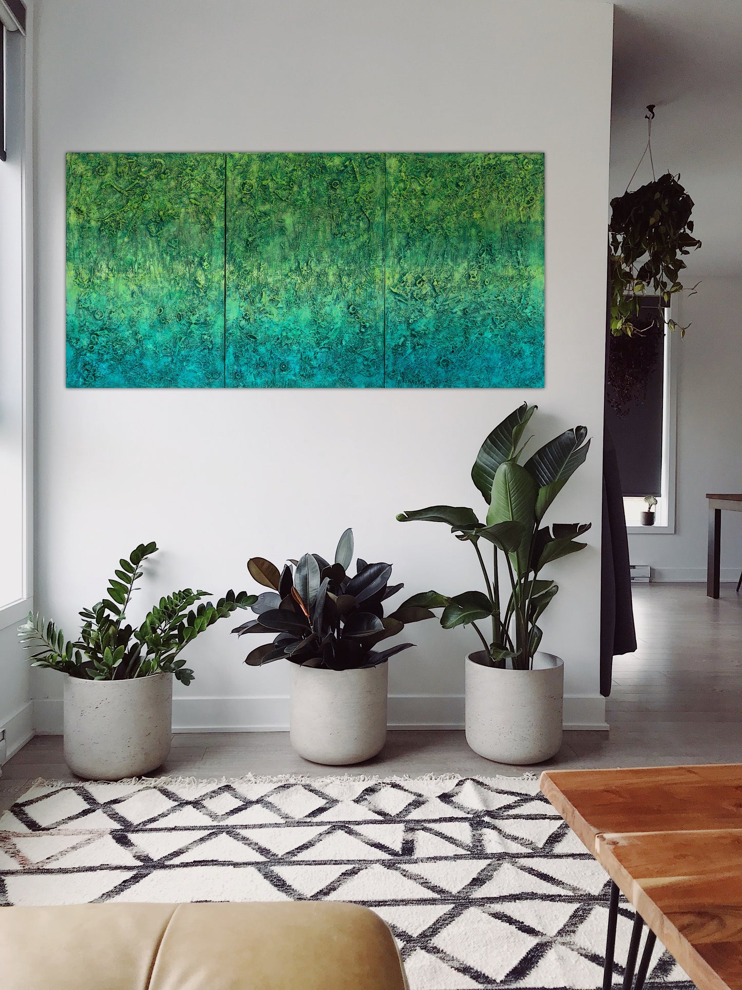 ‘The Grounding’ abstract painting by Pamela Rys, adding serene pranic healing energy to a living room, with dynamic green hues and textured layers.