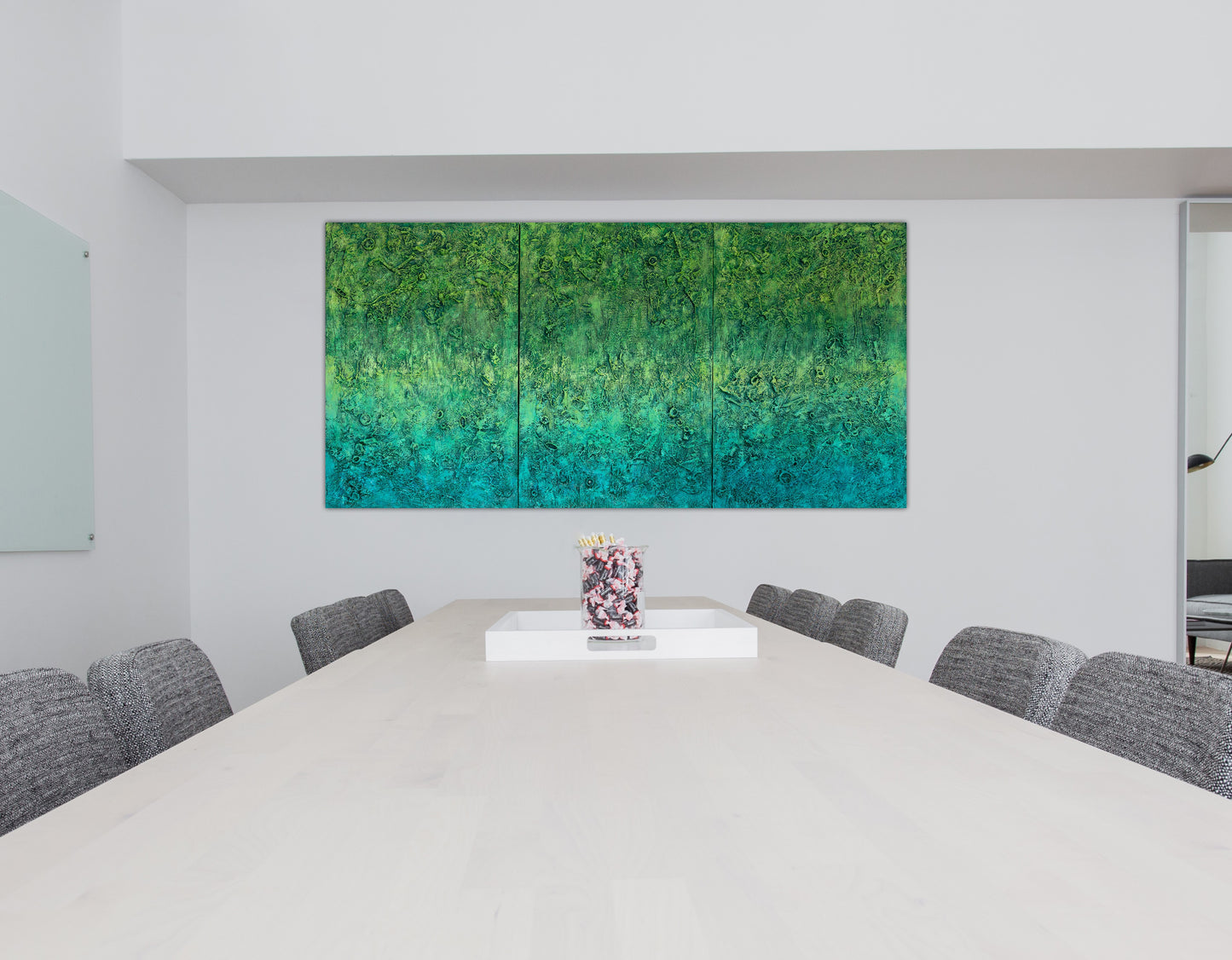‘The Grounding’ abstract art by Pamela Rys in an office setting, providing a calming and grounding energy through its vibrant green tones.